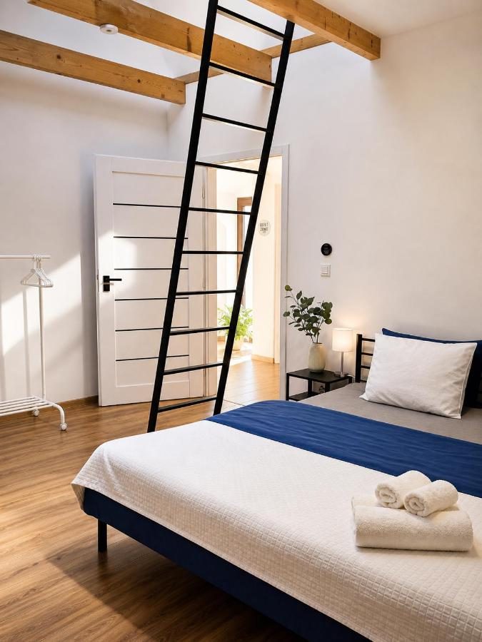 Apartmán Javor — manželská postel a žebřík k vyvýšenému spaní